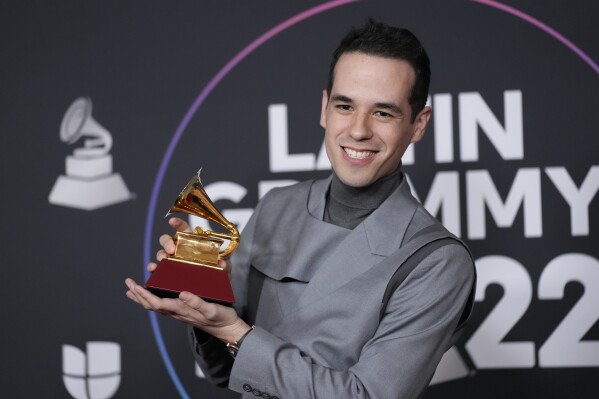FILE - Edgar Barrera poses in the press room with the award for best regional song for "Como Lo Hice Yo" at the 23rd annual Latin Grammy Awards on Nov. 17, 2022, in Las Vegas. Barrera is nominated for 13 Latin Grammy Awards. The 24th Annual Latin Grammy Awards will take place on Nov. 16, in Sevilla, Spain. (AP Photo/John Locher, File)