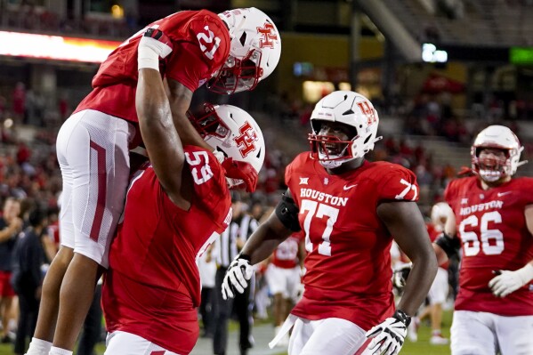 Houston running back Stacy Sneed (21) celebrates after his touchdown with offensive lineman Demetrius Hunter during the second half of an NCAA college football game against Sam Houston State, Saturday, Sept. 23, 2023, in Houston. (AP Photo/Eric Christian Smith)