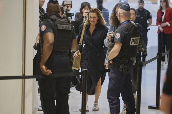 A plaintiff arrives in a Paris court, which is set to deliver a verdict on accusations that French actor Gerard Depardieu sexually assaulted two women who were working on a film with him in 2021, in Paris, Tuesday, May 13, 2025. (AP Photo/Thomas Padilla)