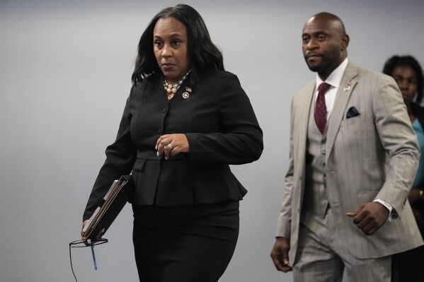 FILE - Fulton County District Attorney Fani Willis, followed by special prosecutor Nathan Wade, right, arrives for a news conference at the Fulton County Government Center, Monday, Aug. 14, 2023, in Atlanta. Willis acknowledged in a court filing on Friday, Feb. 2, 2024, having a “personal relationship” with Wade, a special prosecutor she hired for the Georgia election interference case against former President Donald Trump, but argued there are no grounds to dismiss the case or to remove her from the prosecution. (AP Photo/John Bazemore, File)