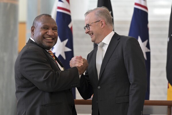 Australia's Prime Minister Anthony Albanese, right, greets Papua New Guinea's Prime Minister James Marape, left, at Parliament House in Canberra, Australia, Thursday, Feb. 8, 2024. (Mick Tsikas/AAP Image via AP)
