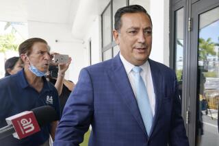 FILE - Then-Miami police Chief Art Acevedo arrives at Miami City Hall for a hearing to determine his job, on Oct. 14, 2021, in Miami. Fired Miami police chief Art Acevedo will become the latest person to serve as the interim leader of police in a Colorado city where police officers and paramedics are being prosecuted in the death of a Black man in 2019. Aurora, a city east of Denver, announced Tuesday, Nov. 15, 2022, that Acevedo will serve as the city's second interim police chief as its search for a permanent chief drags on. (AP Photo/Marta Lavandier, File)