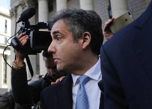 
              Michael Cohen walks out of federal court, Thursday, Nov. 29, 2018, in New York, after pleading guilty to lying to Congress about work he did on an aborted project to build a Trump Tower in Russia.  Cohen told the judge he lied about the timing of the negotiations and other details to be consistent with Trump's "political message." (AP Photo/Julie Jacobson)
            