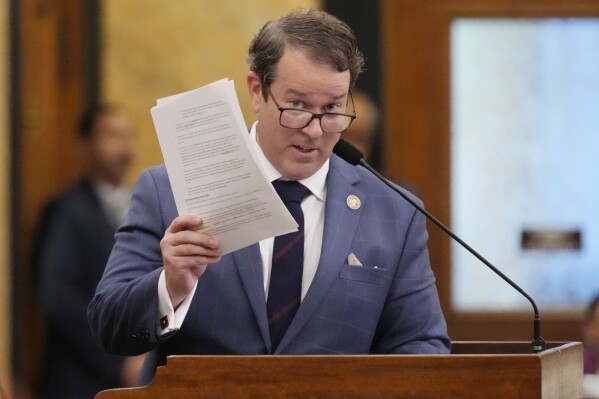 Mississippi State Rep. Fred Shanks, R-Brandon, waves a copy of his proposed resolution that would allow Mississippi residents to put policy proposals on statewide ballots, except for abortion and a few other issues, Wednesday, Jan. 24, 2024, at the Mississippi State Capitol in Jackson. The Republican-dominated House approved the resolution in an 80-36 vote.(AP Photo/Rogelio V. Solis)