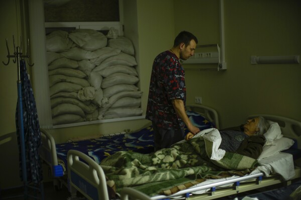 CORRECTS YEAR TO 2023 - FILE - Doctor Ivan Mozhaiev attends to a patient during morning rounds at Pokrovsk hospital in Pokrovsk, eastern Ukraine, on May 22, 2022. Fidelity Charitable, the nation’s largest grantmaker, distributed a record-setting $11.8 billion to nonprofits in 2023, up more than 5% from the previous year at a time when generally donations are dropping. Doctors Without Borders USA and St. Jude Children’s Research Hospital were the most popular charities again, as they were in 2022. (AP Photo/Francisco Seco, File)