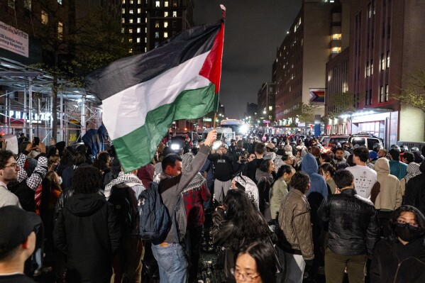 Pro-Palestinian protesters gather near an area where people were being taken into custody near the Columbia University campus in New York, Tuesday, April 30, 2024, after a campus encampment and a campus building, taken over by protesters earlier in the day, were cleared by New York City police. (AP Photo/Craig Ruttle)
