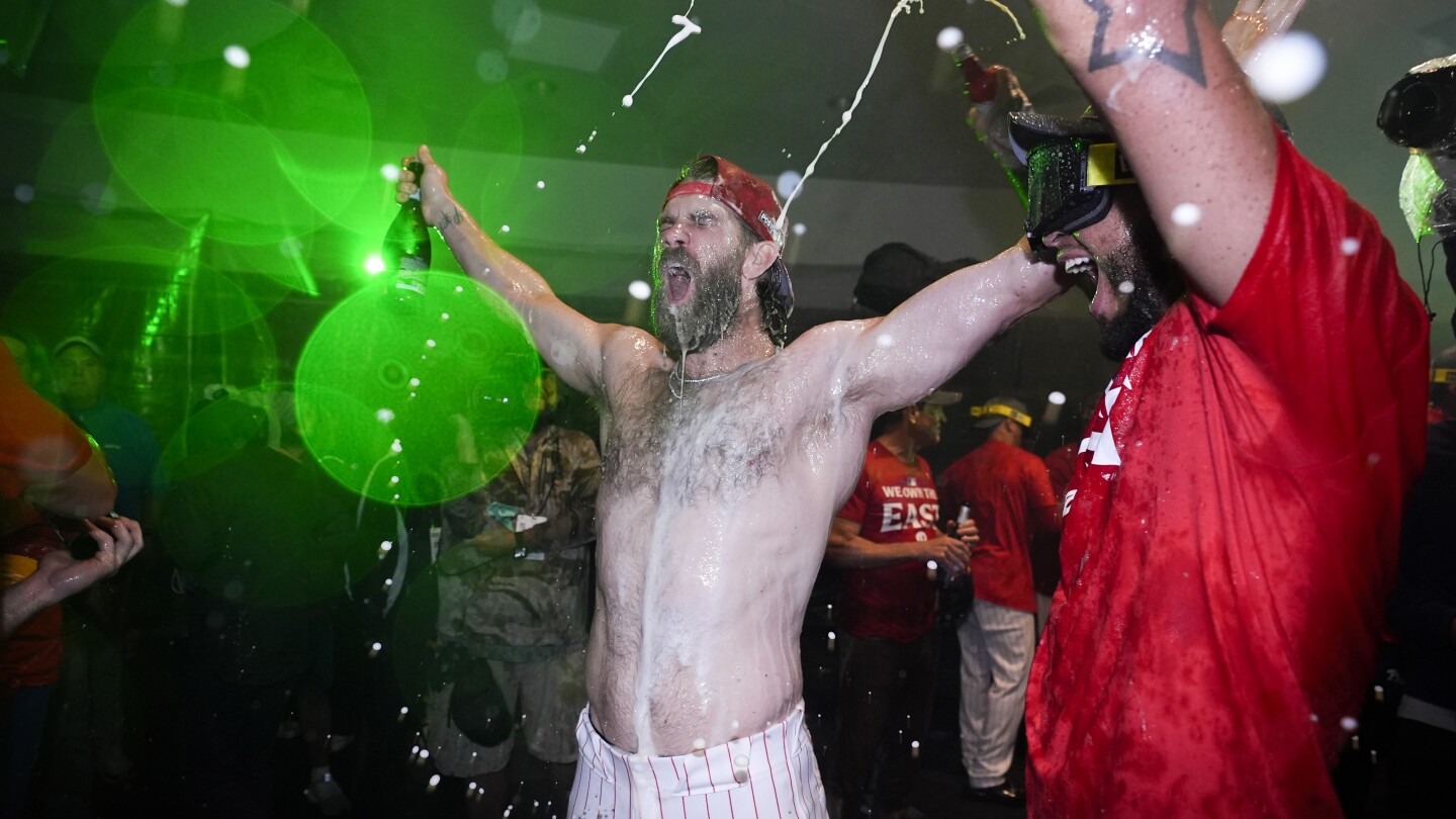 Schwarber and Realmuto hit home runs and the Phillies beat the Cubs 6-2 to win their first NL East title since 2011