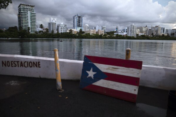 FILE - A wooden Puerto Rican flag is displayed on the dock of the Condado lagoon in San Juan, Puerto Rico, Sept. 30, 2021. The U.S. territory is seeing a growing number of displaced renters and a spike in housing costs, according to a Feb. 21, 2024 report by the Hispanic Federation. (AP Photo/Carlos Giusti, File)