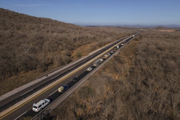 Ostok Sanctuary staff members transport animals in trucks to Mazatlan, Sinaloa state, from the refuge in the outskirts of Culiacan, Sinaloa state, Mexico, Tuesday, May 20, 2025. (AP Photo/Felix Marquez)