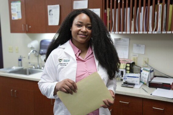 Dr. Starling Tolliver, a dermatology resident at Wayne State University poses at Wayne Health in Dearborn, Mich., Tuesday, Aug. 1, 2023. (AP Photo/Paul Sancya)
