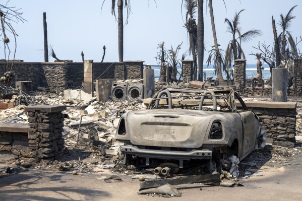 Wildfire wreckage is seen Wednesday, Aug. 9, 2023, in Lahaina, Hawaii. The scene at one of Maui's tourist hubs on Thursday looked like a wasteland, with homes and entire blocks reduced to ashes as firefighters as firefighters battled the deadliest blaze in the U.S. in recent years. (Tiffany Kidder Winn via AP)
