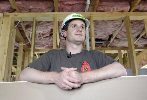 
              FILE - In this Sept. 26, 2018, file photo, Democratic congressional candidate Dan McCready leans against wallboard as he pauses during a Habitat For Humanity building event in Charlotte, N.C. The nation's last unresolved fall congressional race with McCready against Republican Mark Harris is awash in doubt as North Carolina election investigators concentrate on a rural county where absentee-ballot fraud allegations are so flagrant they've put the Election Day result into question. (AP Photo/Chuck Burton, File)
            