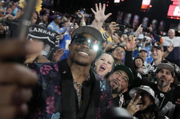 Texas Tech defensive lineman Tyree Wilson takes a selfie with fans after being chosen by the Las Vegas Raiders with the seventh overall pick during the first round of the NFL football draft, Thursday, April 27, 2023, in Kansas City, Mo. (AP Photo/Charlie Riedel)