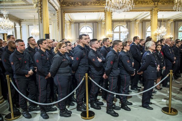 
              Paris Firefighters' brigade and security forces who took part to the fire extinguishing operations of the Notre Dame of Paris Cathedral listen to French President Emmanuel Macron at the Elysee Palace in Paris, Thursday, April 18, 2019. France paid a daylong tribute Thursday to the Paris firefighters who saved the internationally revered Notre Dame Cathedral from collapse and rescued many of its treasures.(Christophe Petit Tesson, Pool via AP)
            