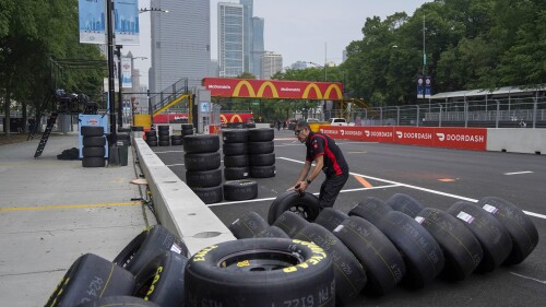 Joe Gibbs racing crew member John Ianham checks tires as preparation for the inaugural NASCAR Chicago Street Race Weekend continues Friday, June 30, 2023, in downtown Chicago. (AP Photo/Erin Hooley)