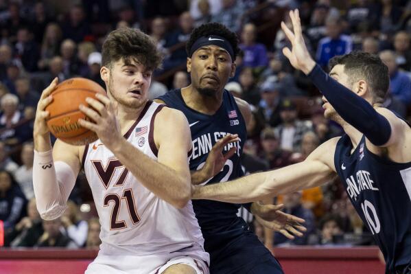 Virginia Tech's Grant Basile (21) goes up for a shot as Penn State's Andrew Funk (10) defends in the second half of an NCAA college basketball game at the Charleston Classic in Charleston, S.C., Friday, Nov. 18, 2022. (AP Photo/Mic Smith)