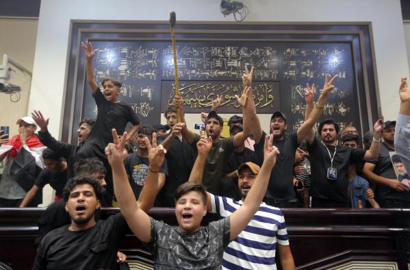 Iraqi protesters fill the parliament building in Baghdad, Iraq, Sunday, July 31, 2022. Thousands of followers of an influential Shiite cleric stormed into Iraq's parliament on Saturday, for the second time in a week, protesting government formation efforts led by his rivals, an alliance of Iran-backed groups. (AP Photo/Anmar Khalil)