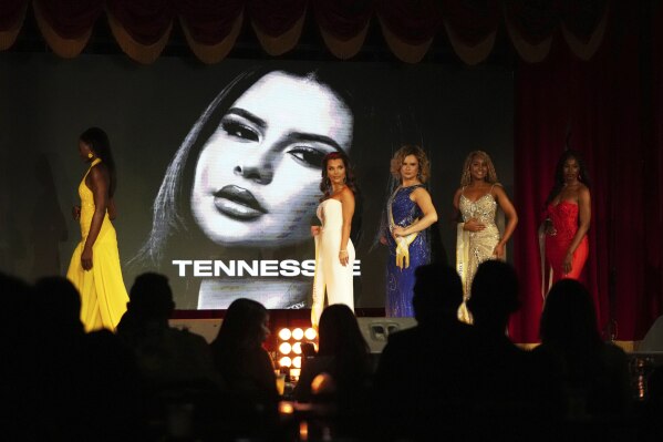 Bella Bautista, 22, third from left, a trans woman, walks on the stage with fellow contestants as her portrait is displayed during the Miss Supranational USA pageant, Saturday, May 17, 2025, in Miami. Bautista says she is the first trans woman to compete in this pageant. (AP Photo/Lynne Sladky)