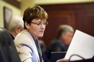 FILE - Democratic Rep. Melissa Wintrow, of Boise, looks at a paper before presenting legislation at the House Judiciary, Rules and Administration Committee meeting in the House Hearing Room in the Idaho Statehouse, Feb. 15, 2016. On Monday, March 27, 2023, the Idaho Senate voted 22-12 to pass a bill criminalizing gender-affirming healthcare for minors, one month after the state House passed similar legislation. Before the vote, Wintrow read a letter from a constituent pleading with lawmakers to reject the bill. (Greg Kreller/The Idaho Press-Tribune via AP, File)