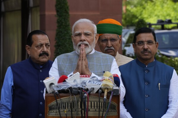 Indian Prime Minister Narendra Modi,center, greets the media as he arrives for five-day special session of the Parliament, in New Delhi, India, Monday, Sept. 18, 2023. Monday's sitting is the last one to be held in the old parliament building and the future proceedings will be moved to a new building from Tuesday. (AP Photo/Manish Swarup)