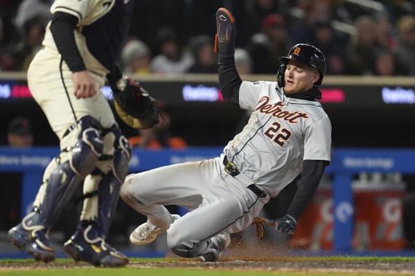 Detroit Tigers' Parker Meadows (22) scores on a single by Wenceel Pérez against the Minnesota Twins during the ninth inning of a baseball game Friday, April 19, 2024, in Minneapolis. (AP Photo/Abbie Parr)