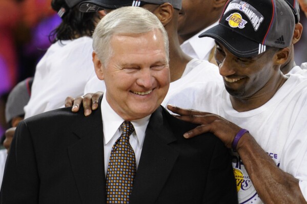 FILE - Los Angeles Lakers' Kobe Bryant gives basketball great Jerry West a shoulder rub after the Lakers beat the San Antonio Spurs in Game 5 of the NBA Western Conference basketball finals in Los Angeles, May 29, 2008. Jerry West, who was selected to the Basketball Hall of Fame three times in a legendary career as a player and executive and whose silhouette is considered to be the basis of the NBA logo, died Wednesday morning, June 12, 2024, the Los Angeles Clippers announced. He was 86. (AP Photo/Kevork Djansezian, File)
