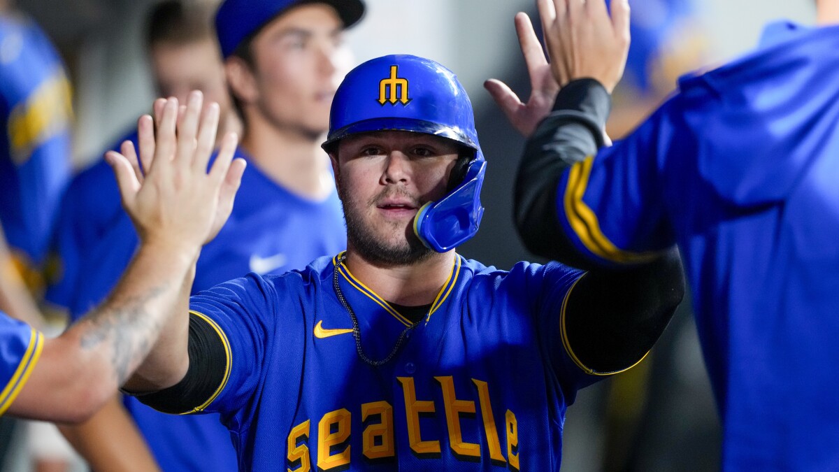 Seattle Mariners' Teoscar Hernandez in the dugout holding the trident used  for home run celebrations after his against the St. Louis Cardinals during  a baseball game, Saturday, April 22, 2023, in Seattle. (