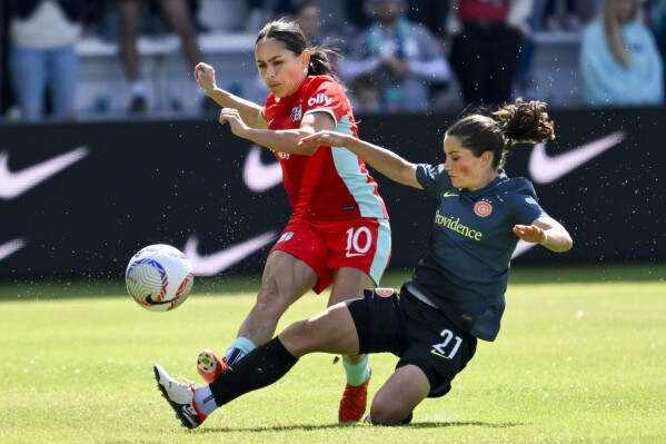 Kansas City Current midfielder Lo'eau LaBonta (10) plays the ball as Portland Thorns FC midfielder Jessie Fleming (21) challenges during an NWSL soccer match at CPKC Stadium, Saturday, March 16, 2024, in Kansas City, Mo. (AP Photo/Reed Hoffmann, File)