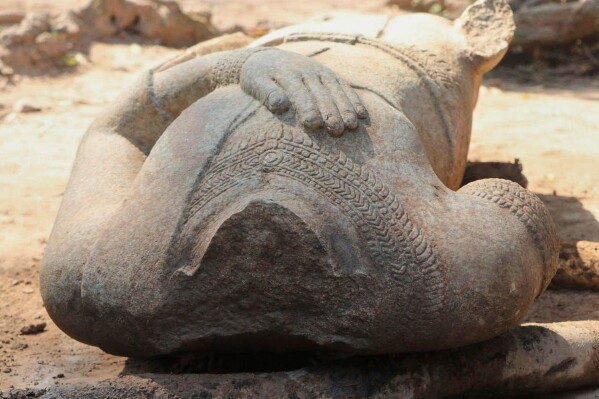 This February 2025 image provided by the Apsara National Authority, shows a headless statue excavated by archaeologists at the Angkor temple complex in Cambodia's Siem Reap province. According to archaeologists, the head of the same statue was dug up in 1927 and is now in Cambodia's National museum in the capital Phnom Penh, and the two parts may be reattached for display. (Apsara National Authority via AP)