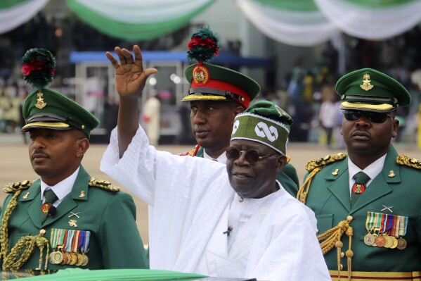 FILE - Nigeria's new President Bola Ahmed Tinubu, center, inspects honour guards after taking an oath of office at a ceremony in Abuja, Nigeria, Monday, May 29, 2023. An appeals court in Nigeria was to rule Wednesday, Sept. 6, 2023, on whether President Bola Tinubu's election victory in February was legitimate, a highly anticipated decision that has put Africa's most populous country on edge. (AP Photo/Olamikan Gbemiga, File)