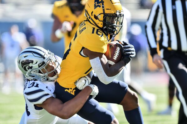 West Virginia  wide receiver Winston Wright Jr. (16) is tackled after a catch by Kansas State defensive back Jahron McPherson (31) during an NCAA college football game Saturday, Oct. 31, 2020, in Morgantown, W.Va. (William Wotring/The Dominion-Post via AP)