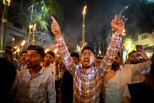 All Assam Students Union (AASU) members take out a torch procession to protest against the Citizenship Amendment Act (CAA) in Guwahati, India, Tuesday, March 12, 2024. India has implemented a controversial citizenship law that has been widely criticized for excluding Muslims, a minority community whose concerns have heightened under Prime Minister Narendra Modi's Hindu nationalist government. The act provides a fast track to naturalization for Hindus, Parsis, Sikhs, Buddhists, Jains and Christians who fled to Hindu-majority India from Afghanistan, Bangladesh and Pakistan before Dec. 31, 2014. (AP Photo/Anupam Nath)