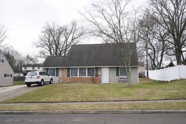 A vehicle is parked in the driveway of a home that was a scene of a murder in Levittown, Pa., on Wednesday, Jan. 31, 2024. A graphic video from a man accused of beheading his father that circulated for hours on YouTube has put a spotlight yet again on gaps in social media companies’ ability to prevent horrific postings from spreading across the web. Police said Wednesday that they charged 32-year-old Justin Mohn with first-degree murder and abusing a corpse after he beheaded his father in their Bucks County home. (Jessica Griffin/The Philadelphia Inquirer via AP)