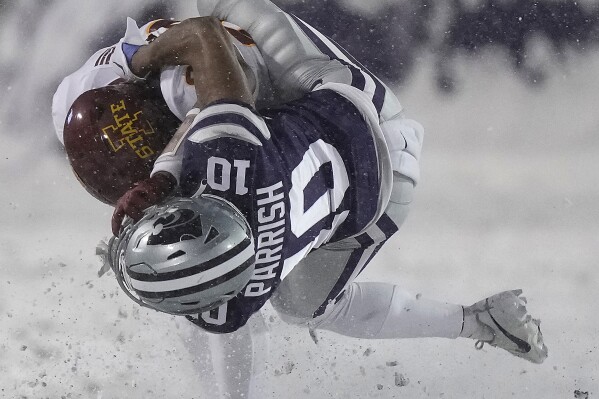 Kansas State cornerback Jacob Parrish (10) tackles Iowa State running back Abu Sama III during the first half of an NCAA college football game Saturday, Nov. 25, 2023, in Manhattan, Kan. (AP Photo/Charlie Riedel)