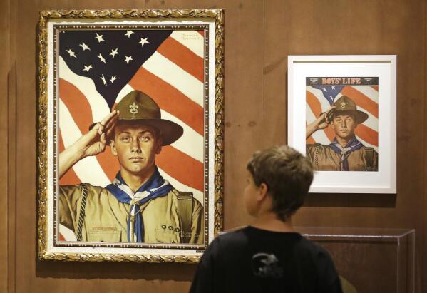 FILE - In this July 22, 2013, file photo, an 11-year-old boy looks over a Boy Scout-themed Norman Rockwell exhibition at the Church History Museum in Salt Lake City, Utah. The Mormon church, the largest sponsor of Boy Scouts troops in the United States, announced Thursday, May 11, 2017, it is pulling older teenagers from the organization as the religion takes a step toward developing its own global scouting-like program. (AP Photo/Rick Bowmer, File)