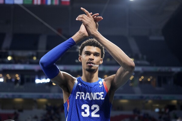 France's Victor Wembanyama claps as he leaves the court after France defeated Japan in a men's basketball game at the 2024 Summer Olympics, Tuesday, July 30, 2024, in Villeneuve-d'Ascq, France. (AP Photo/Michael Conroy)