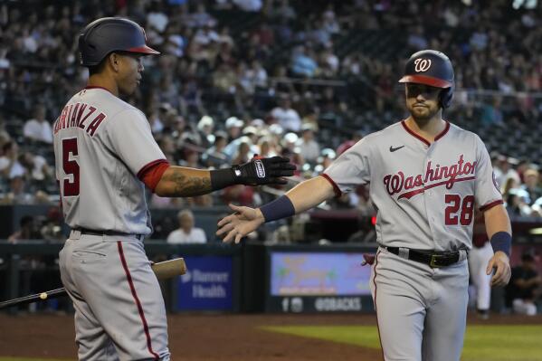 Minnesota Twins' Ehire Adrianza (13) celebrates in the dugout after he  slides into home plate, scoring during the fourth inning of a baseball game  against the Miami Marlins on Thursday, Aug. 1