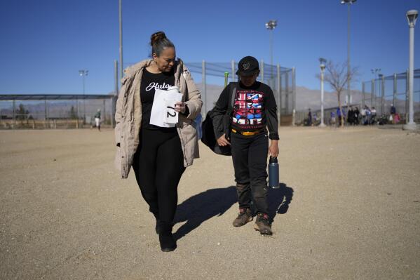 Doreen Hall Vann walks with son Zaiden after tryouts for a club baseball team Saturday, Jan. 21, 2023, in Las Vegas. In 2019 Vann moved from Hawaii to Las Vegas to be closer to her daughter in Seattle. (AP Photo/John Locher)