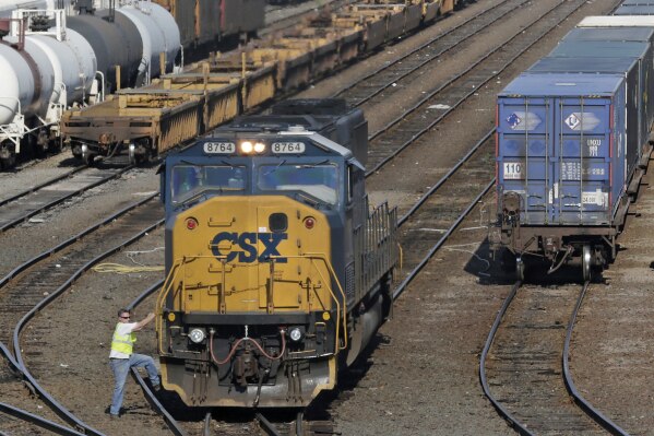 FILE - In this Thursday, July 12, 2012, photo, a rail yard worker climbs off a switching engine at the CSX facility in Boston. CSX Corp. reports earnings on Thursday, Oct. 19, 2023. (AP Photo/Charles Krupa, File)