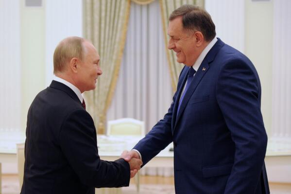 Russian President Vladimir Putin, left, and Milorad Dodik, the Serb member of Bosnia and Herzegovina's tripartite presidency, shake hands during a meeting in the Kremlin in Moscow, Russia, Tuesday, Sept. 20, 2022. (Grigory Sysoev, Sputnik, Kremlin Pool Photo via AP)