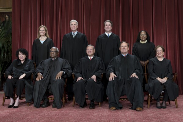 FILE - Members of the Supreme Court sit for a new group portrait following the addition of Associate Justice Ketanji Brown Jackson, at the Supreme Court building in Washington, Oct. 7, 2022. Bottom row, from left, Justice Sonia Sotomayor, Justice Clarence Thomas, Chief Justice John Roberts, Justice Samuel Alito, and Justice Elena Kagan. Top row, from left, Justice Amy Coney Barrett, Justice Neil Gorsuch, Justice Brett Kavanaugh, and Justice Ketanji Brown Jackson. The new term of the high court begins next Monday, Oct. 2, 2023. (AP Photo/J. Scott Applewhite, File)