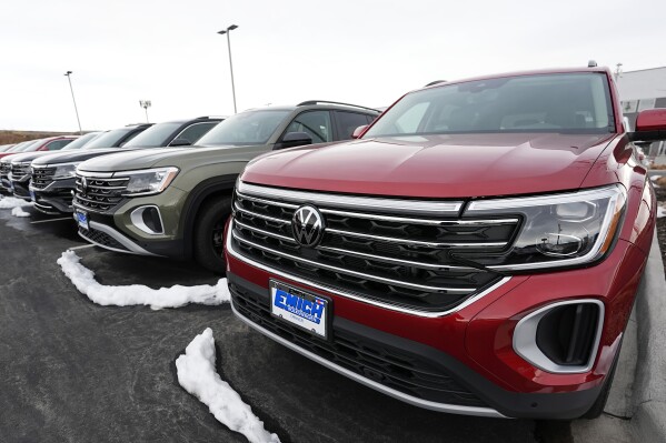 A line of unsold 2024 Atlas sports-utility vehicles sits at a Volkswagen dealership Sunday, March 17, 2024, in Denver. Most automakers who sell new vehicles in the U.S. report first-quarter sales numbers on Tuesday, April 2, 2024. Sales are expected to be surprisingly strong despite high interest rates. (AP Photo/David Zalubowski)