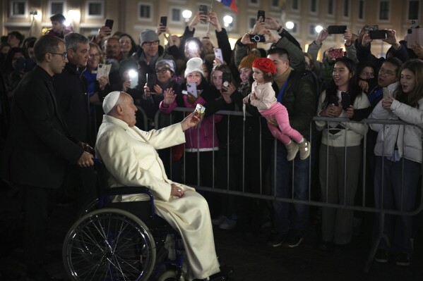 Pope Francis waves faithfuls after celebrating over New Year's Eve Vespers and Te Deum, in St.Peter's Square at the Vatican, Tuesday, Dec. 31, 2024. (AP Photo/Andrew Medichini)