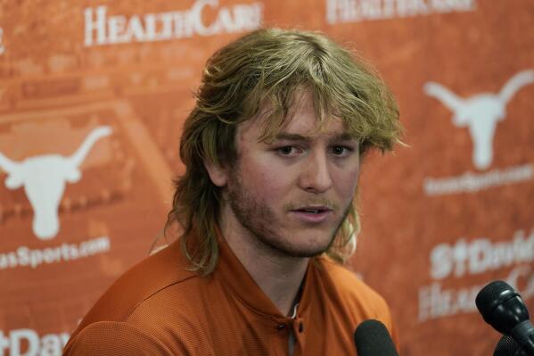 FILE - Texas NCAA college football quarterback Quinn Ewers talks to the media following a spring practice, Thursday, April 14, 2022, in Austin, Texas. Freshman Quinn Ewers has been named the starting quarterback after transferring from Ohio State (AP Photo/Eric Gay, File)
