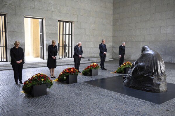 German Federal President Frank-Walter Steinmeier, center, lays a wreath at the Neue Wache, the Federal Republic of Germany's central memorial to the victims of war and tyranny, with representatives of the federal constitutional bodies from left, Anke Rehlinger, Minister-President of Saarland and current President of the Bundesrat, Bundestag President Julia Klöckner, Federal Chancellor Friedrich Merz, and Stephan Harbarth, President of the Federal Constitutional Court, in Berlin, Thursday, May 8, 2025, on the 80th anniversary the Second World War in Europe came to an end. (Bernd von Jutrczenka/dpa via AP)