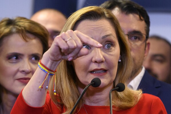 Elena Lasconi, the Save Romania Union (USR) party candidate for president speaks to media after polls closing during the country's presidential elections, in Bucharest, Romania, Sunday, Nov. 24, 2024. (AP Photo/Alexandru Dobre)