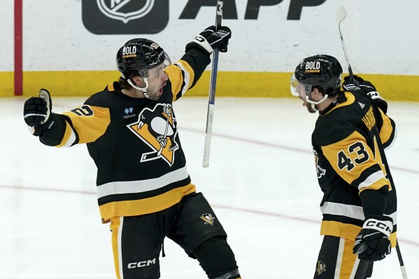 Pittsburgh Penguins' Emil Bemstrom, left, celebrates with Jansen Harkins (43) after scoring against the Nashville Predators during the third period of an NHL hockey game, Monday, April 15, 2024, in Pittsburgh. (AP Photo/Matt Freed)