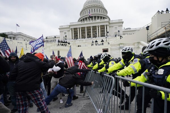 FILE - In this Jan. 6, 2021, file photo, Trump supporters try to break through a police barrier at the Capitol in Washington. For America's allies and rivals alike, the chaos unfolding during Donald Trump's final days as president is the logical result of four years of global instability brought on by the man who promised to change the way the world viewed the United States. (AP Photo/Julio Cortez, File)