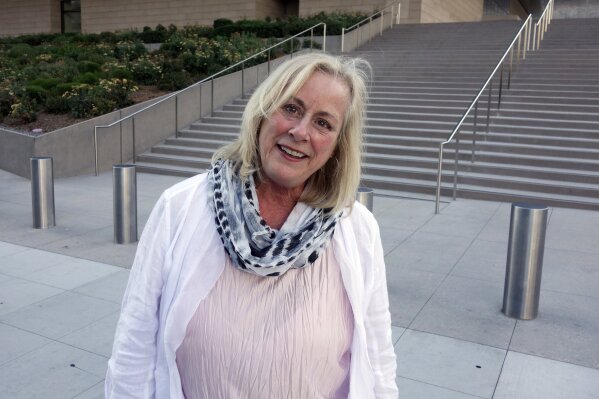 FILE - In this Aug. 29, 2017, file photo, Gail Steinbeck, widow of Thomas Steinbeck, the son of author John Steinbeck, leaves federal court in downtown Los Angeles. A federal appeals court has thrown out $8 million in punitive damages against the daughter-in-law of author John Steinbeck in her long-running copyright spat with the late author's step-daughter. The 9th U.S. Circuit Court of Appeals on Monday, Sept. 9, 2019, upheld a $5 million verdict against Gail Steinbeck and told her it's time to end her legal saga. (AP Photo/Brian Melley, File)