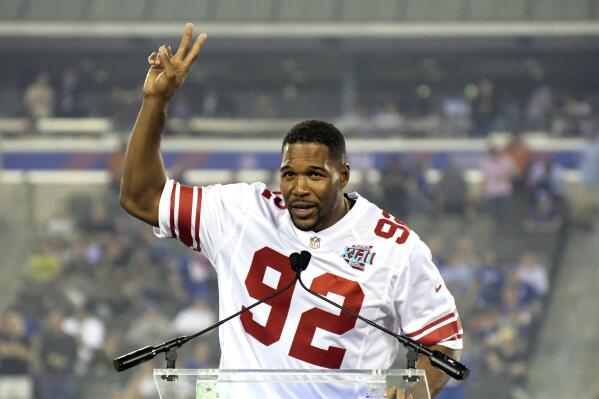 FILE - In this Sept. 18, 2017, file photo, former New York Giants player Michael Strahan gestures during a halftime ceremony of an NFL football game between the Giants and the Detroit Lions in East Rutherford, N.J. The Giants are going to retire the No. 92 jersey of Hall of Fame defensive end Michael Strahan this season. The ceremony will take place on Nov. 28 at MetLife Stadium at a game against the Philadelphia Eagles.
(AP Photo/Bill Kostroun, File)
